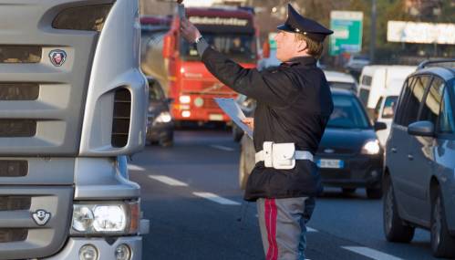 Rome, Italy - January 18, 2008: Agent of the Italian traffic police receives documents from the driver of a truck during a routine check.