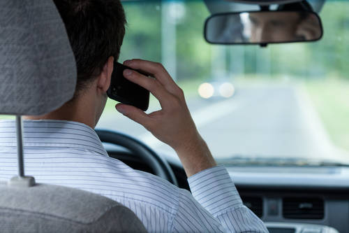 Man talking on phone during driving car
